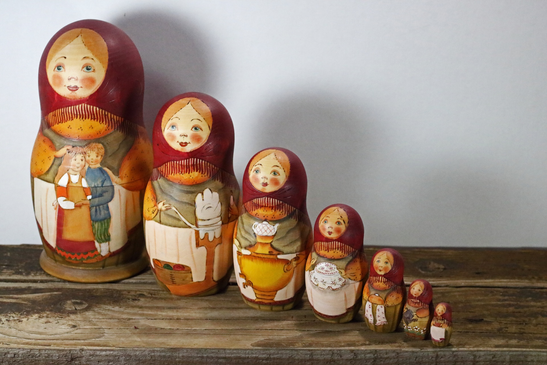 a row of seven sequential matryoshka nesting dolls