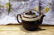 Brown Ceramic Teapot And Silk Cloth
