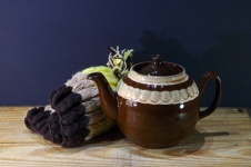 Brown Ceramic Teapot Next To Cozy
