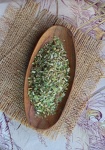Green Herbal Tea In Wooden Bowl