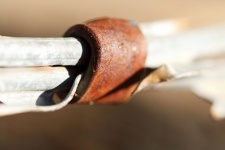 Rusted Metal Clamp Around Wires