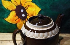 Teapot With Yellow Flower On Cloth