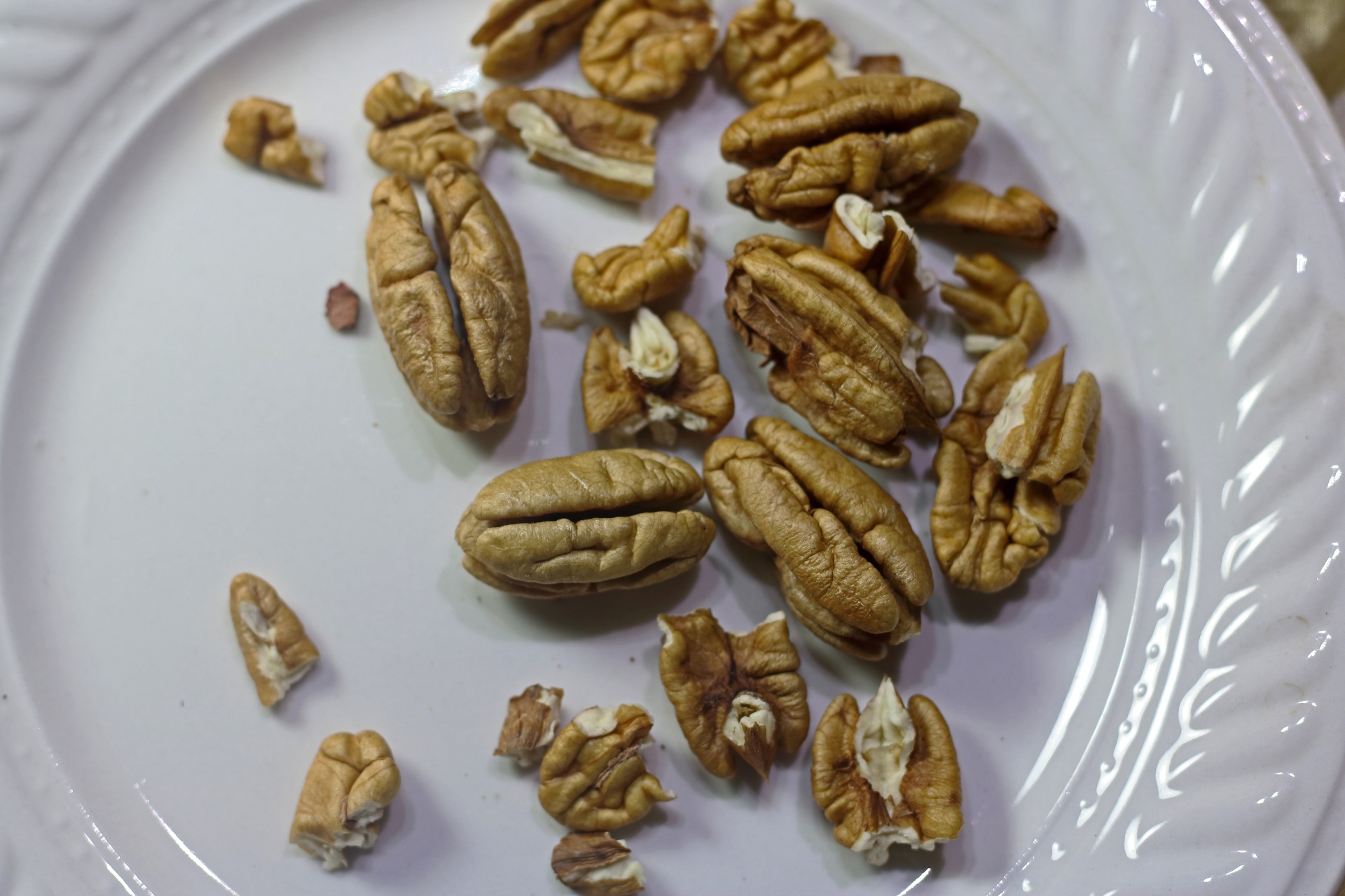 Shelled Pecan Nuts On A White Plate