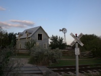 House Windmill And Railroad Crossin