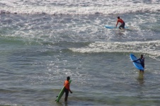 Three Surfers In Water