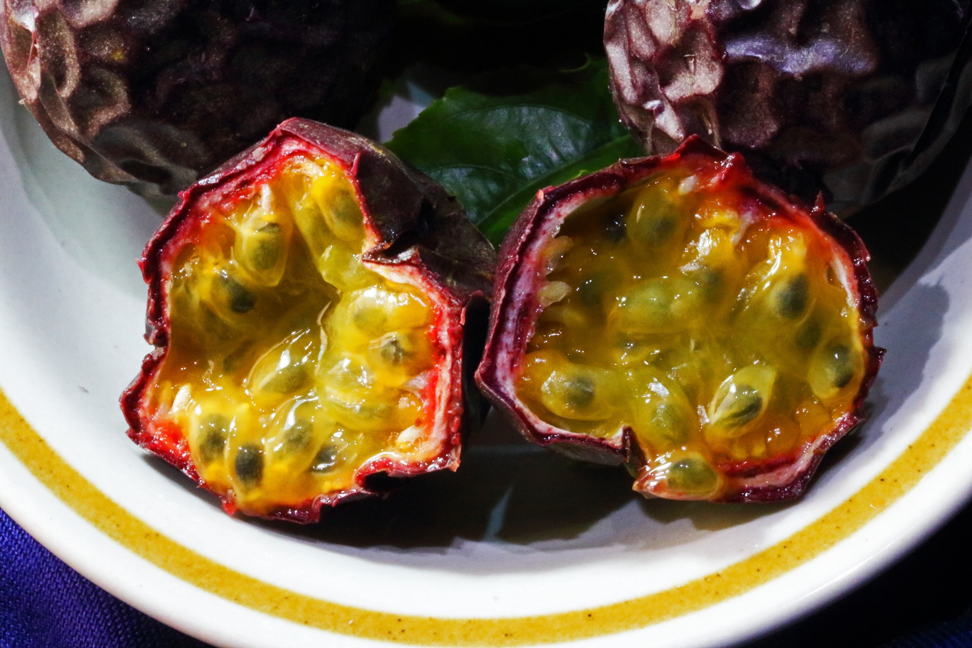 glossy pulp inside a cut passion fruit in a bowl