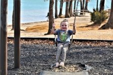 Little Girl On Swing At Lake