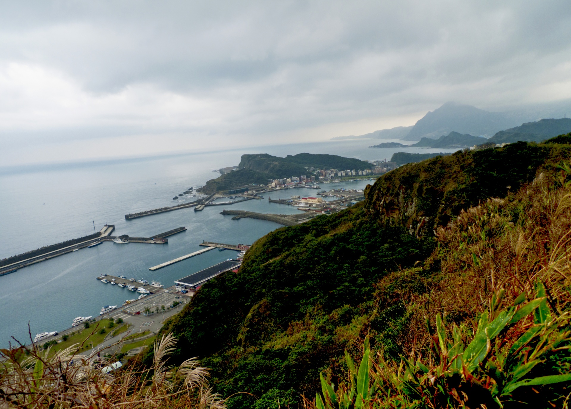 The north-east coastof Taiwan at Badouzi harbour and fishing port, looking east.
