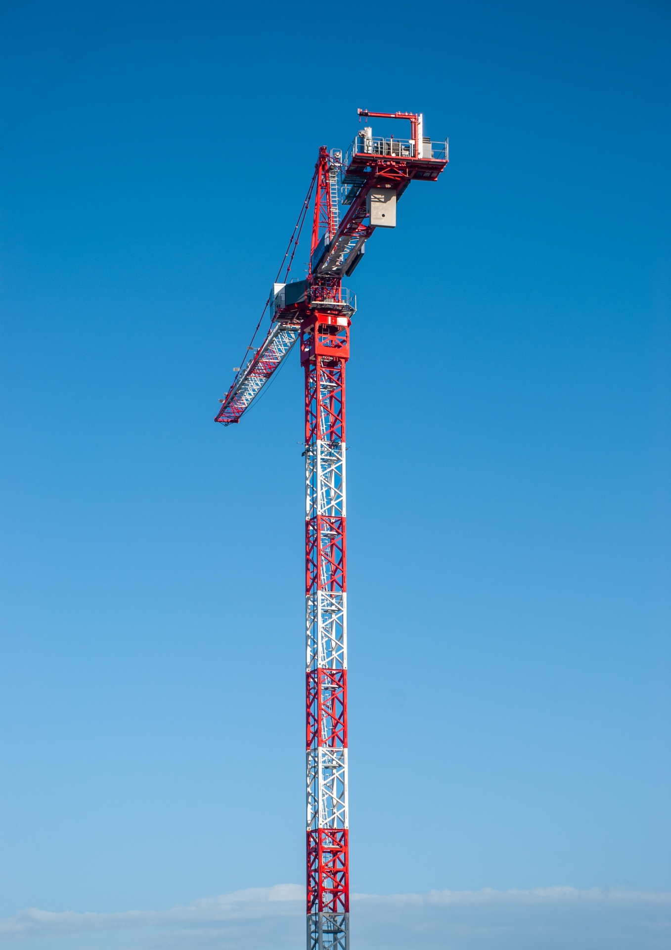 A tower crane on a blue background