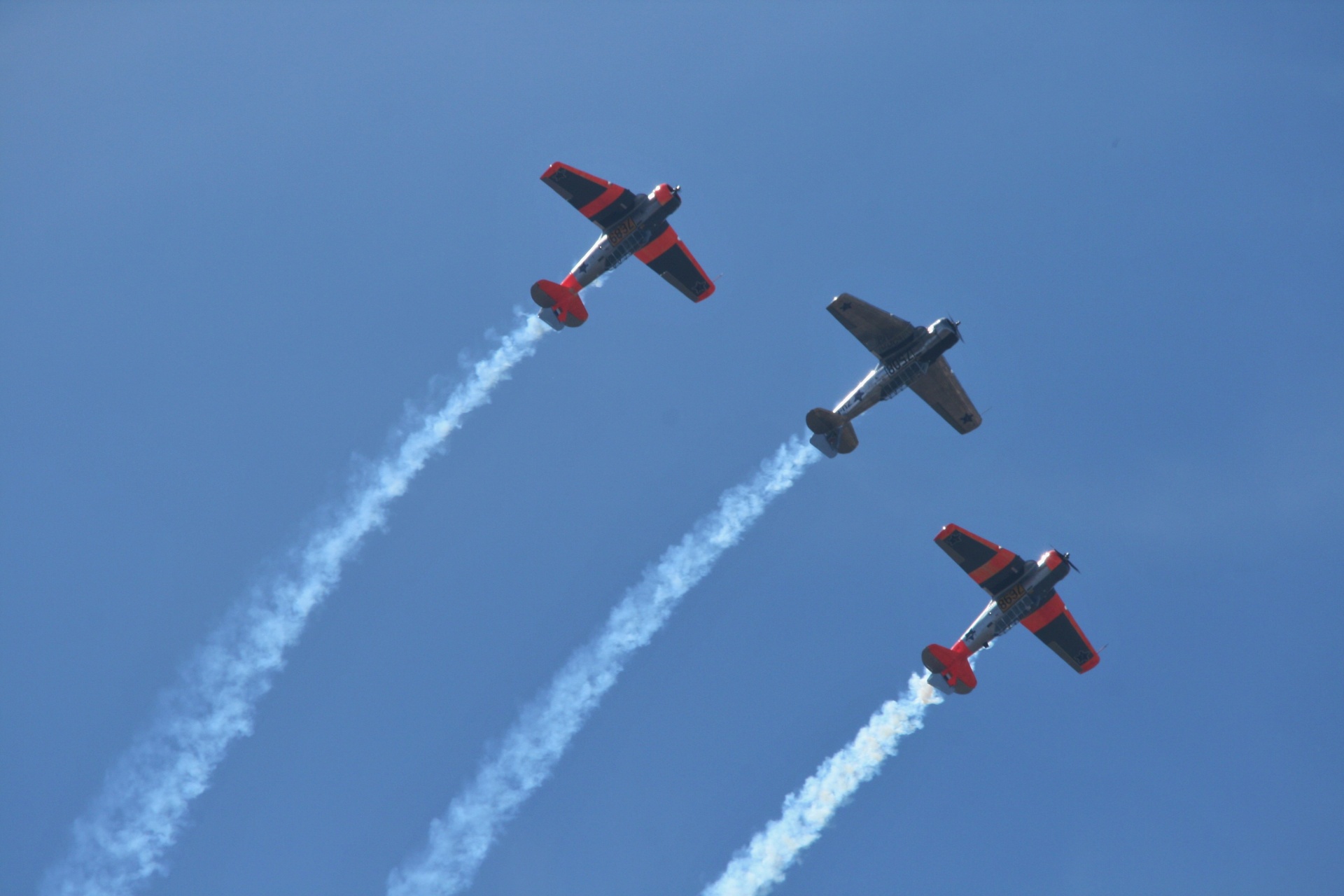 harvard formation flying against blue sky