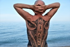 Tattoo Man Looking At The Ocean