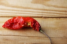 Dried Partially Eaten Chili On Wood