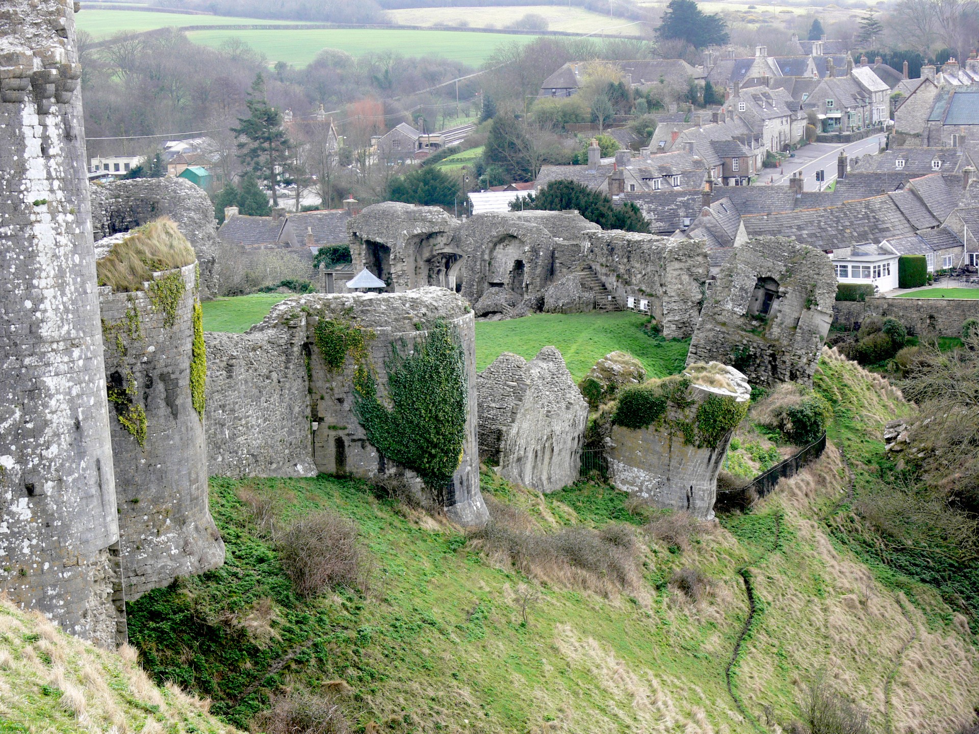 Ruins of Corfe Castle with village of Corfe in the background