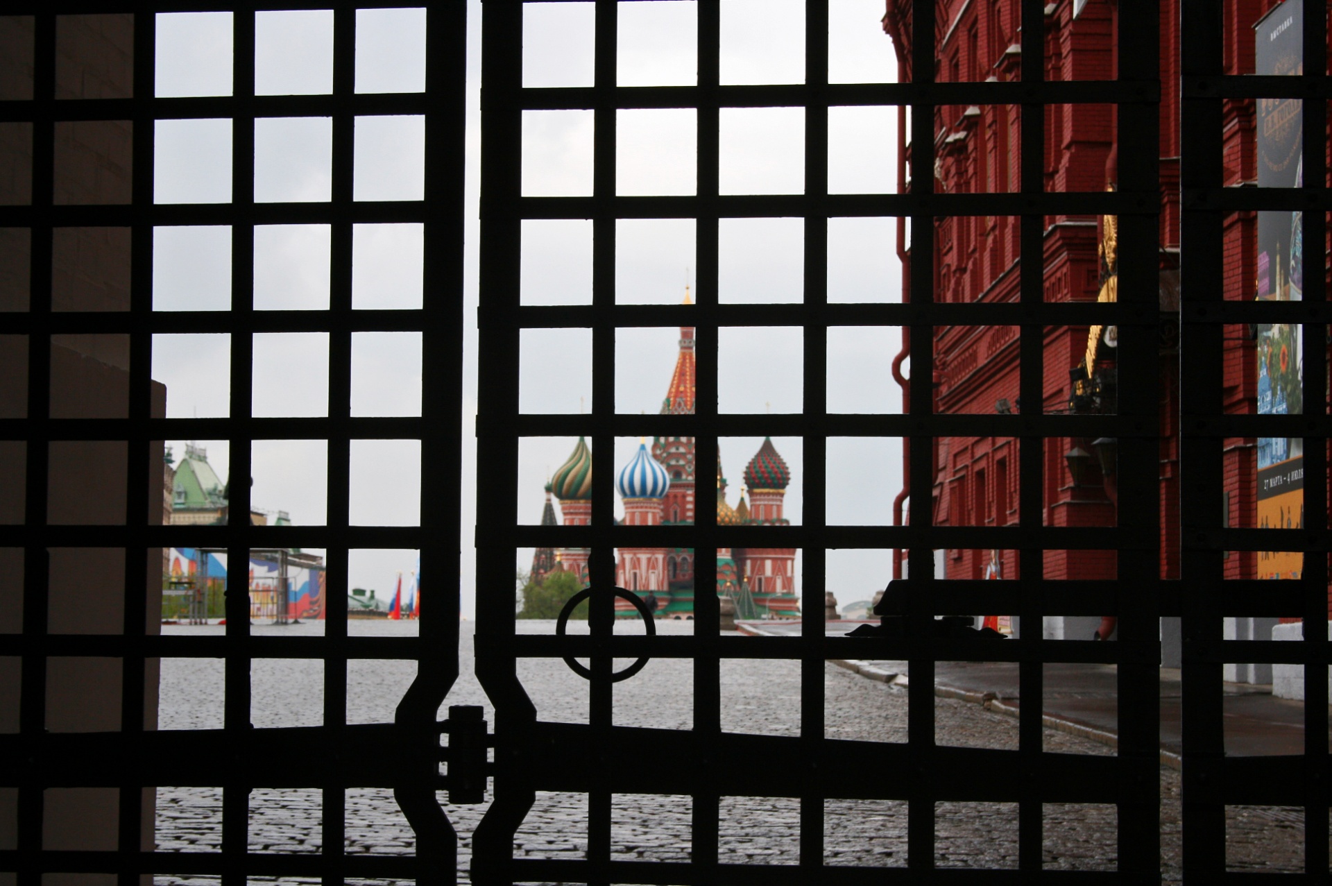 view of st basils cathedral through grid of closed gate in resurrection gate