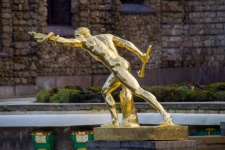 A Golden Statue With A Snake 01