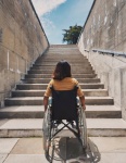 Wheelchair User Looking At Stairway