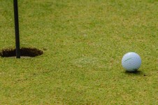 Golf Ball Next To Hole