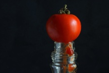 Ripe Red Tomato On Top Of A Bottle