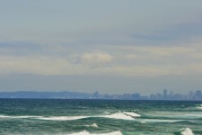 Sea With City Skyline And Bluff
