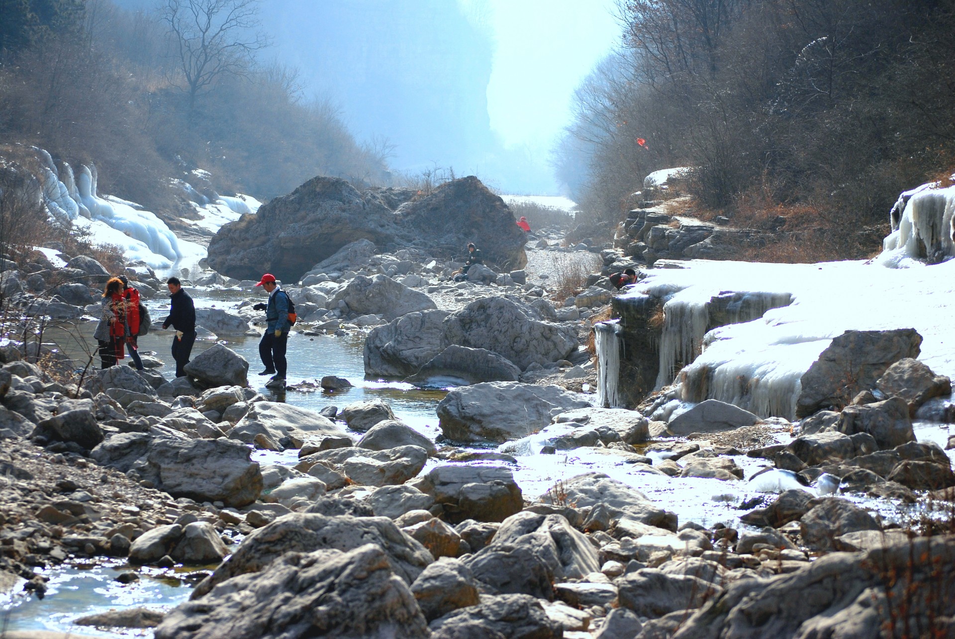 people crossing a mountain stream