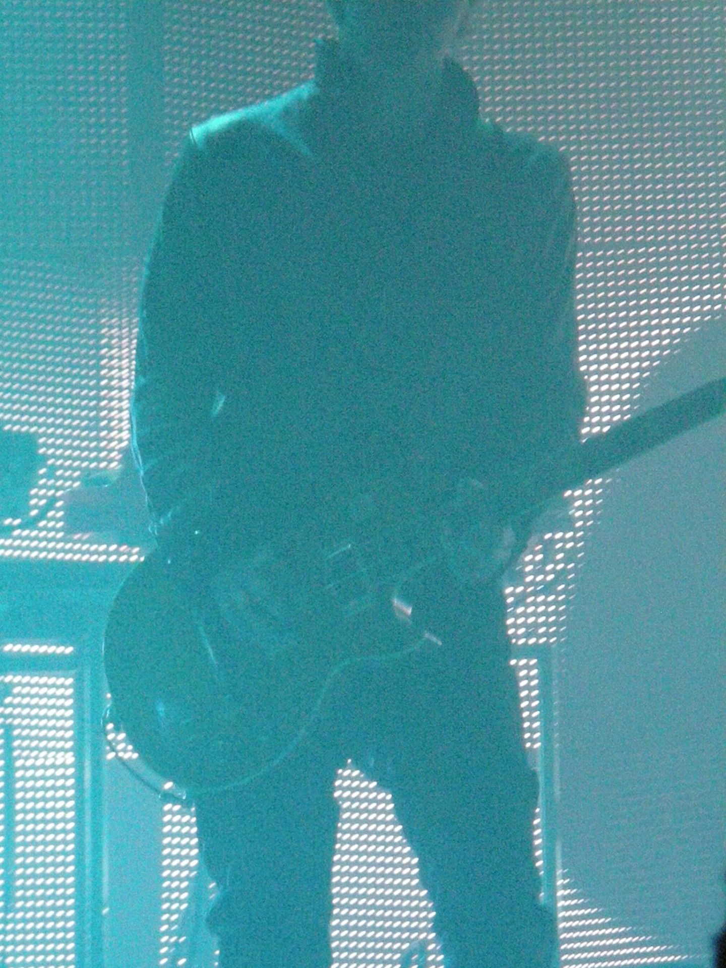 Live rock concert performance, male playing electric guitar blue lights