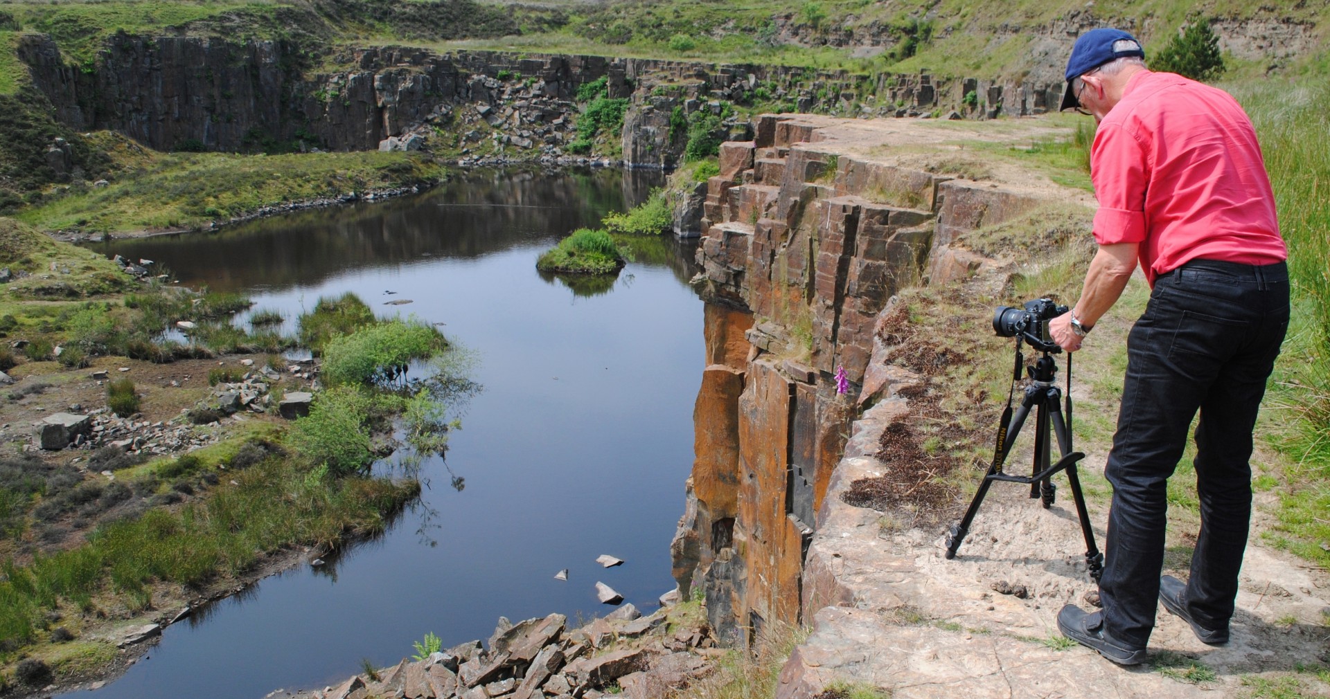 Photographer taking a picture above a quarry