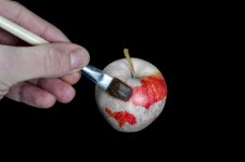 Male Hand Painting Red Apple