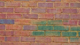 Red Brick Wall With Green Bricks