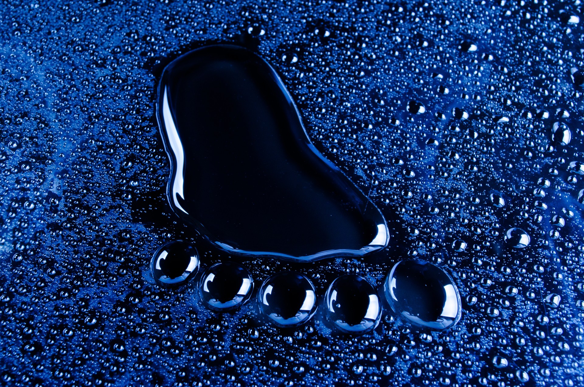 The footprint made up of water on blue background