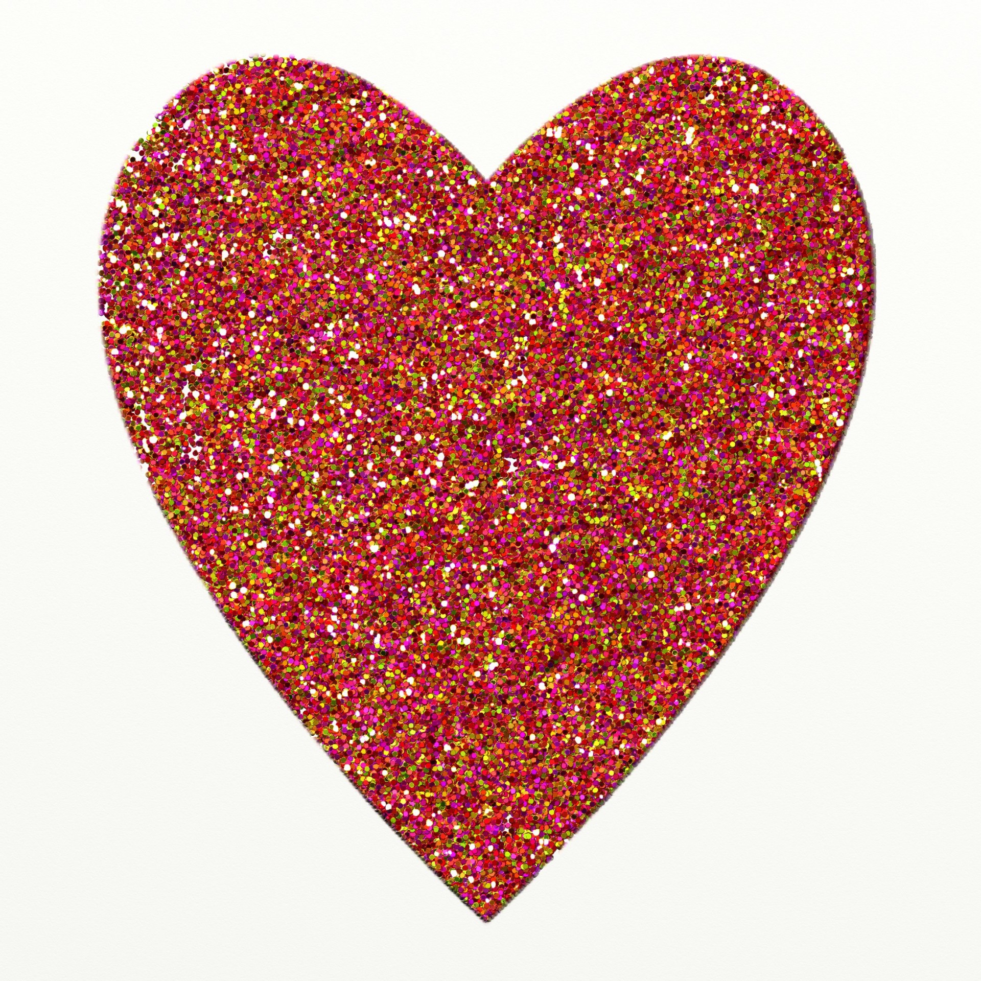 Illustration of a simple heart shape made up of colourful glitter.