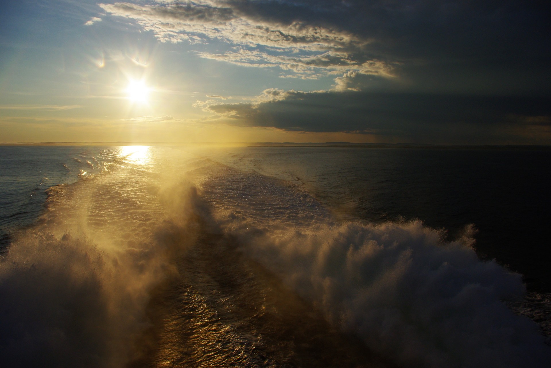 Sunset on the sea with turbulent waves and beautiful clouds