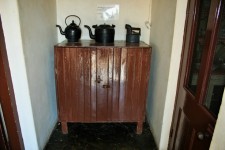 Cupboard With Old Iron & Kettles
