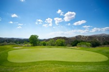 Golfing Green Under Blue Sky